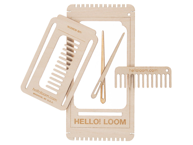A small hand-held loom made of laser-cut wood that comes with two needles and a stand.