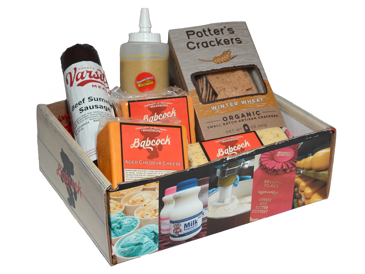 Gift box with cheeses, crackers, summer sausage and mustard.