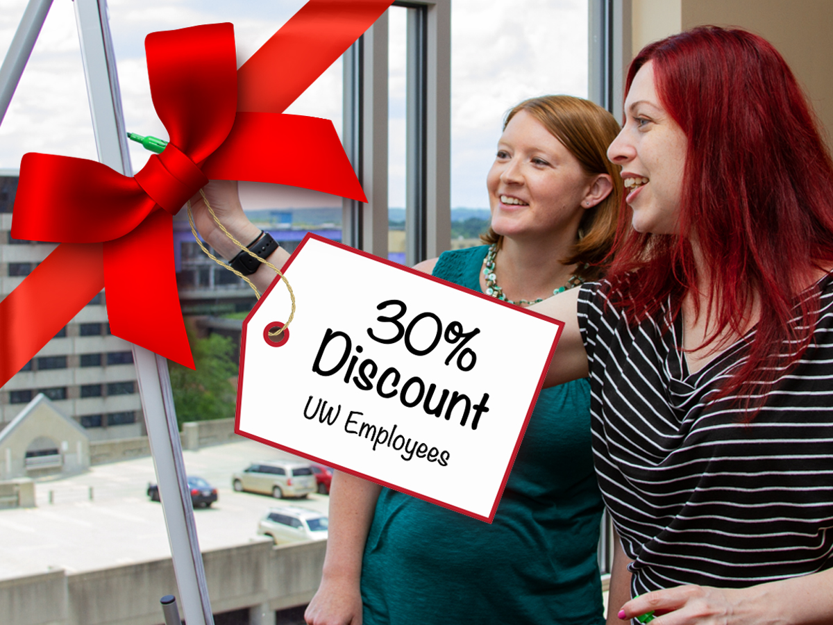 An image of two professional women is covered with a red bow and tag which reads 30 percent discount for UW employees.